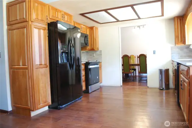 View of the updated kitchen.  Kitchen features newer hand scraped style wood flooring flooring, and brand-new PEX plumbing w/lifetime warranty - bringing peace of mind for years.
