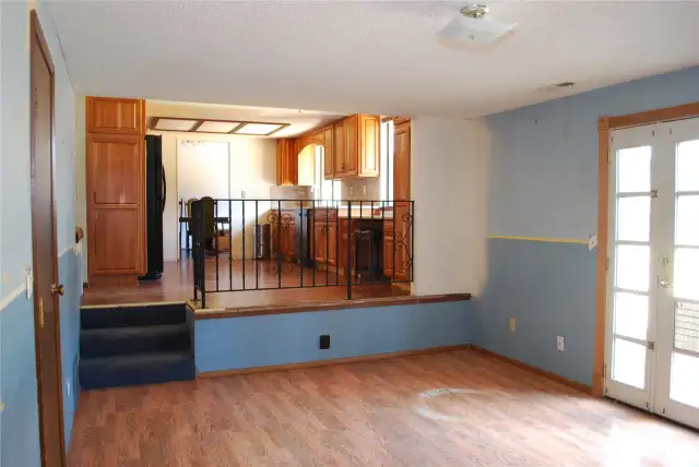 View across the family room with laminate flooring in to the kitchen.  Patio off family room is great for outdoor entertaining, BBQs, or simply relaxing. Plenty of backyard space for an RV and backyard fun, includes shed.