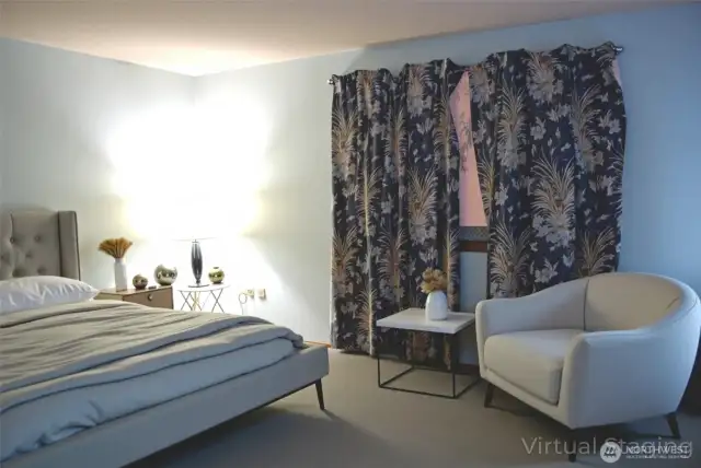Virtually staged view of primary bedroom.  Primary bedroom features a 3/4 bath and a walk-in closet.