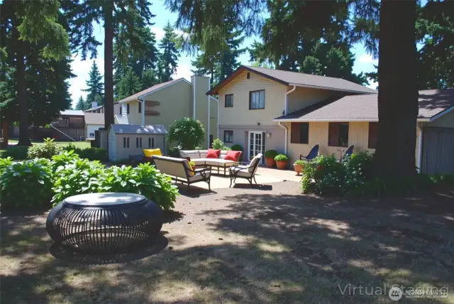 Virtually stage backyard view of this 1,659 sqft, 3 bed, 2.5 bath, tri-level, all nestled on a large corner lot in south hill Puyallup. Patio off family room is great for outdoor entertaining, BBQs, or simply relaxing. Plenty of backyard space for an RV and backyard fun, includes shed.