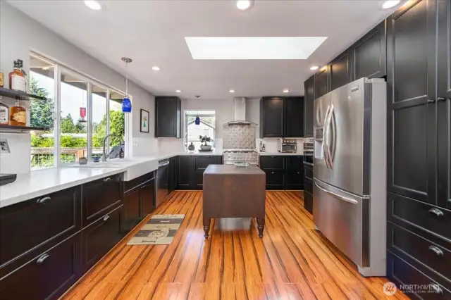 Custom Bamboo floors shine throughout the amazing chef's kitchen.