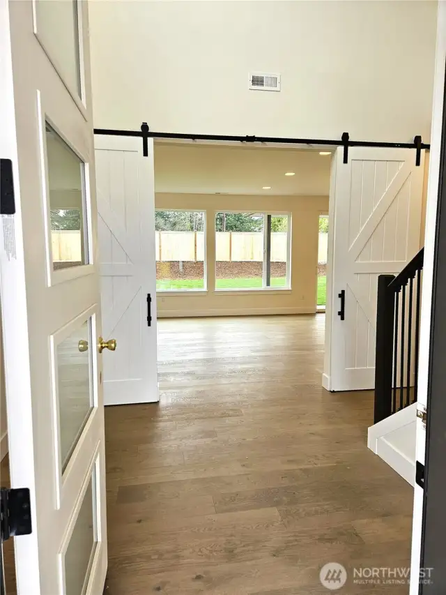 Enter into a home with refined finishes like these stately double barn doors.