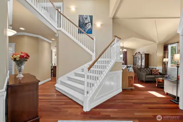 grand entrance features open staircase vaulted ceilings custom lighting, hardwood floors