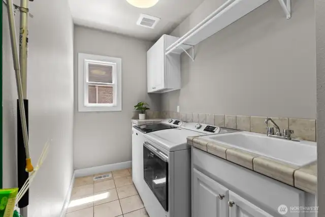 Laundry is fully equipped with storage cabinets, closet right off garage