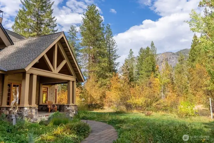 Aerial view of the home, Wilson Ranch Community & Freestone Inn—surrounded by towering peaks, lush forest, and featuring Freestone Lake just steps away. A rare opportunity in the heart of Mazama’s recreational paradise.