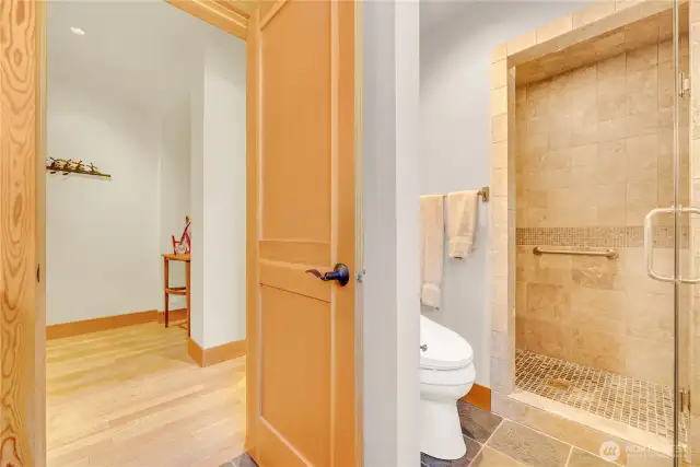 Main floor tile bathroom with glass-enclosed shower.