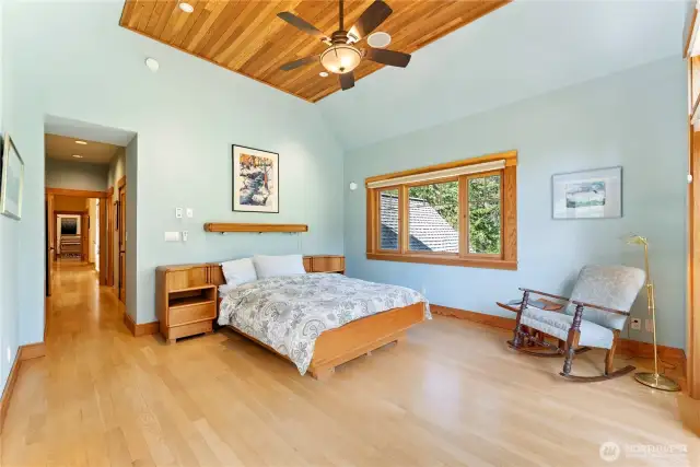 Spacious walk-in closet with custom built-ins and automated window blinds in the serene primary suite.