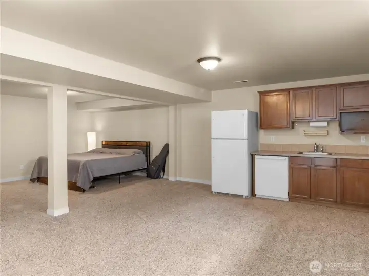Fully finished walk-out basement with wet bar (dishwasher doesn't work). Could be expanded to 2nd kitchen?