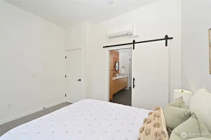 Closet space and barn-door to Primary Suite bath.
