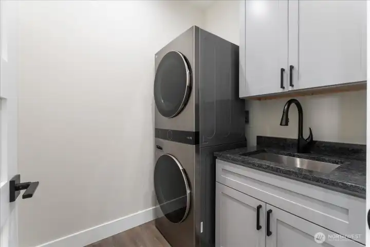 Utility room with sink and storage.