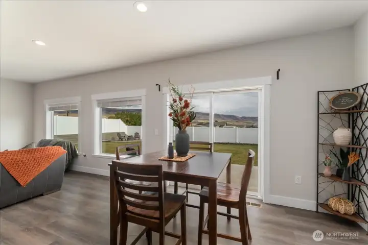 Lovely open living space with gorgeous windows framing backyard and mountain views.
