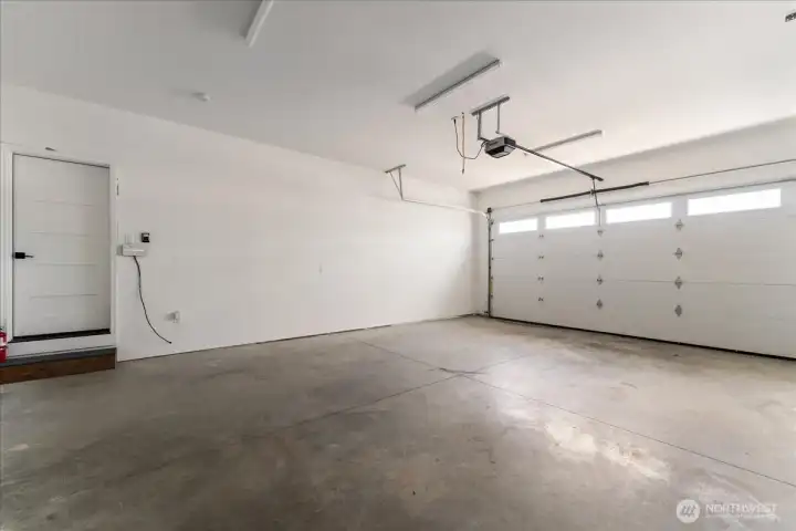Attached double car garage with high ceilings.