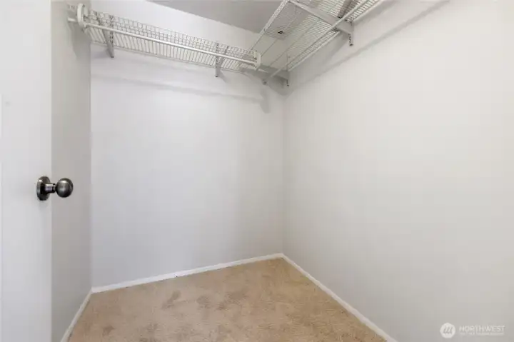 Primary bedroom walk in closet