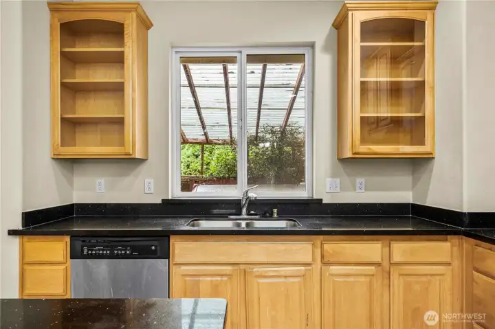 The kitchen look out to the covered hot tub area.  (Inspection report recommends removal).