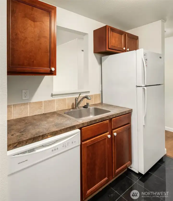 Matching white appliances and kitchen pass through.