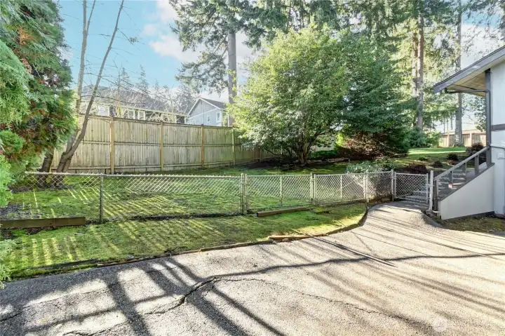 Fully fenced, level & sunny backyard.