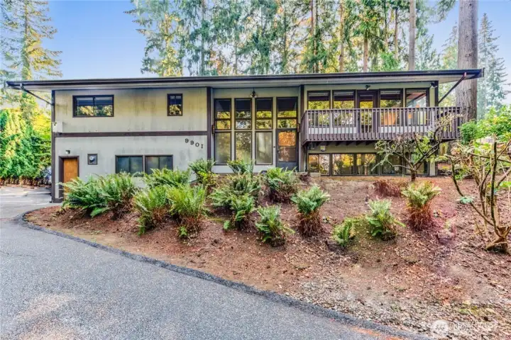 5 yr old photo of the Home with vegetation trimmed back.