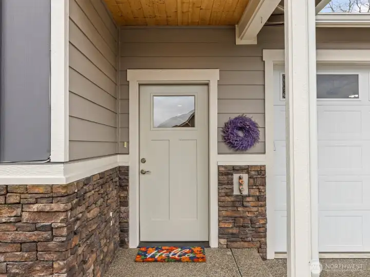 Pine tongue and groove on the covered front porch warmly greets you as you approach the house.