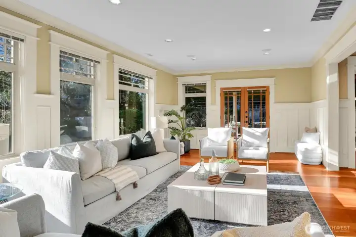 Formal living room opens through French doors to a covered patio