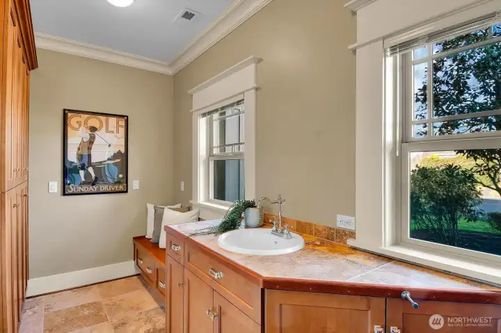 Convenient mud room/walk-in pantry space is tucked down a short hallway near the kitchen