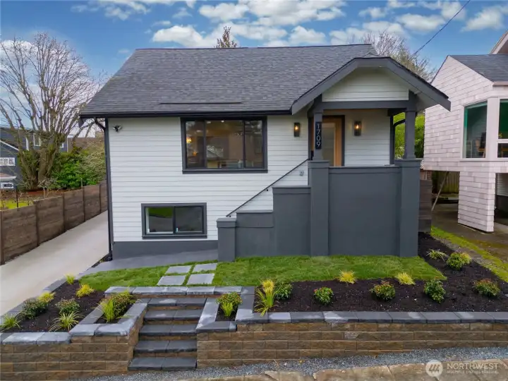 Front exterior showcasing a new roof, windows, siding, and a fully rebuilt exterior envelope, designed for long-term durability and peace of mind