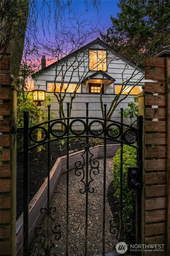 Charming gated entry along garden path to the house.