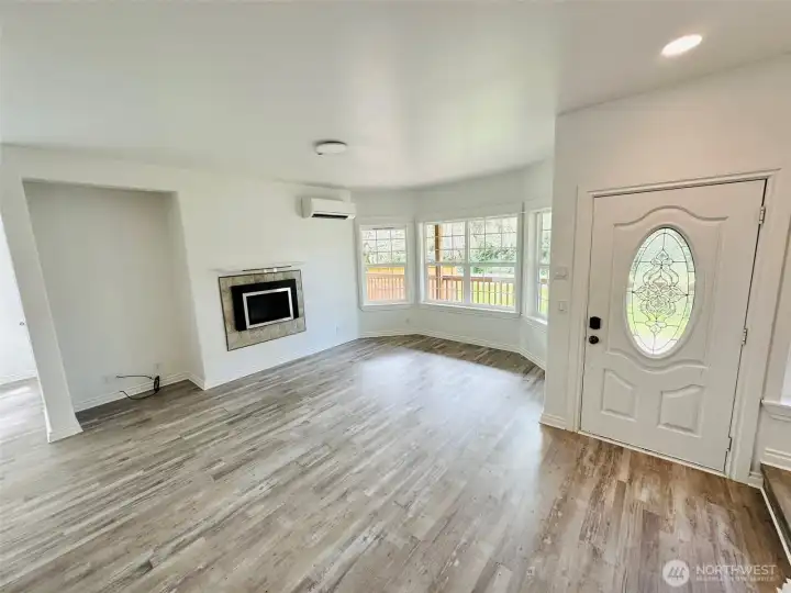 Large Light and Bright living room with propane fireplace and wall of windows