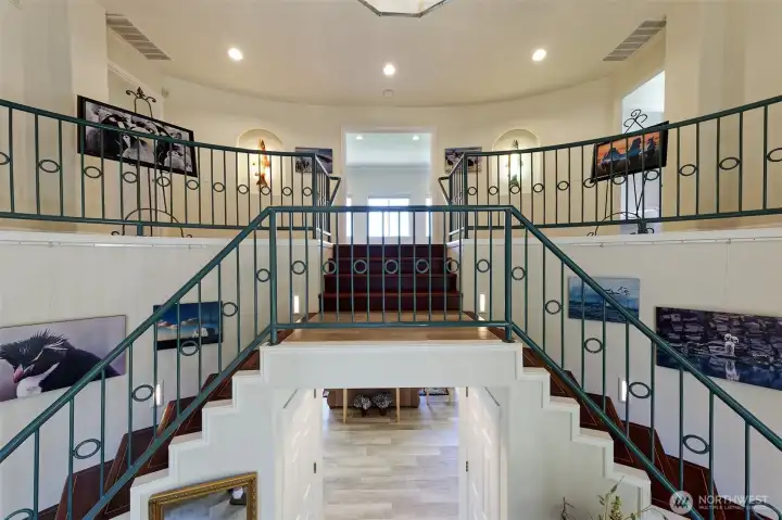 Such a stunning double-stairway that greets you in the entry foyer! Curved staircases with custom stairs made from Brazillian cherry inlaid with maple treads and risers.