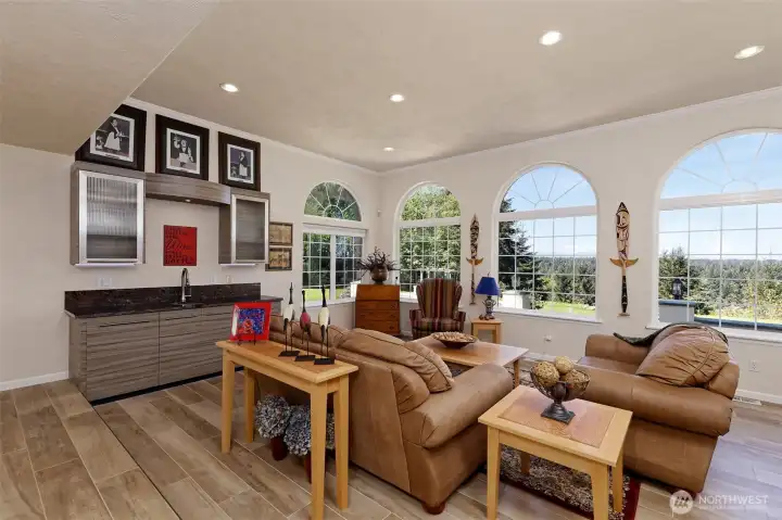 The living room also features a wet bar, and porcelain tile flooring.