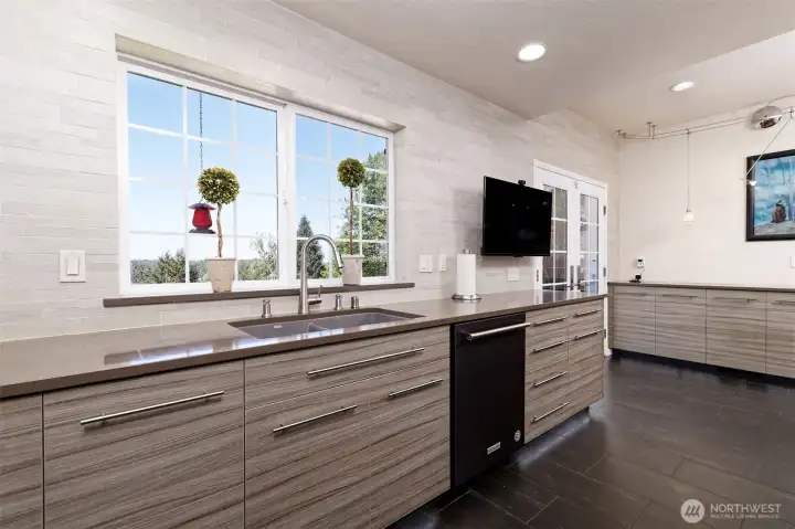 Lovely view to look out at while doing the dishes. Granite and quartz counter tops, toe-kick LED lighting, high-tech main faucet with voice commands controlling temperature and water volume! Works with Alexa or Google.