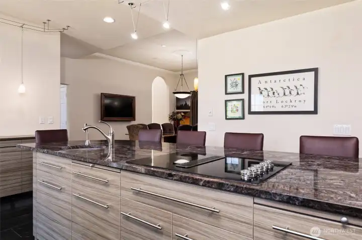 Cooktop island with prep sink, and nice chairs for your guests to sit in and visit with you while you cook.