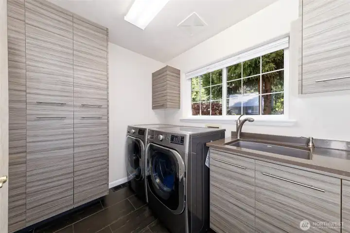Utility room with top-notch appliances that stay, Quartz counters, a utility sink, and even a laundry chute from the second floor.