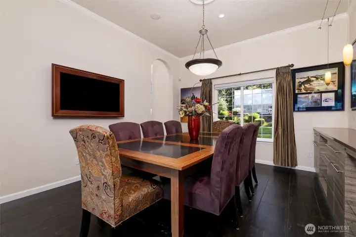 Lovely dining room, with a wood-wrapped TV mounted on the wall that will stay, and a built-in buffet.