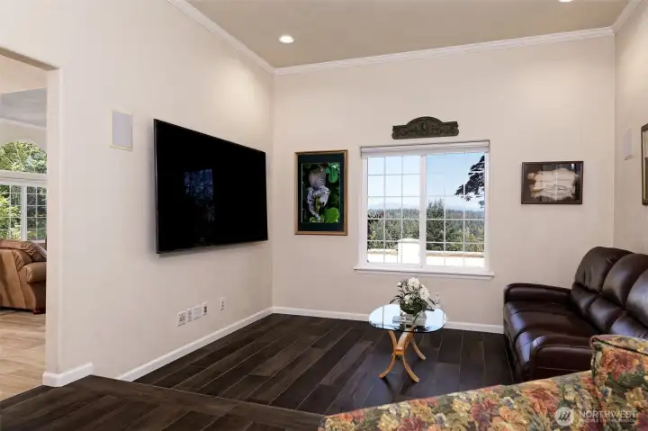Cozy media room, wired for surround-sound, and includes the 86" TV, in-wall speakers, and nice leather recliners.