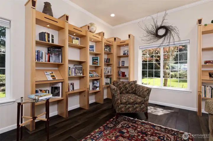 Gorgeous custom-made bookcases, made from maple and purple heart wood. Also includes a pull-out sleeper couch and reading chairs.