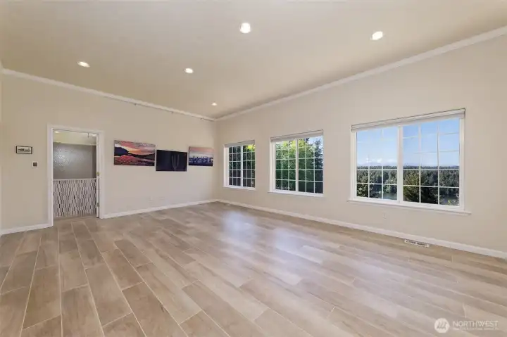 Spacious Primary bedroom! With a great wall of windows to enjoy that beautiful view. Italian porcelain tile HEATED flooring.