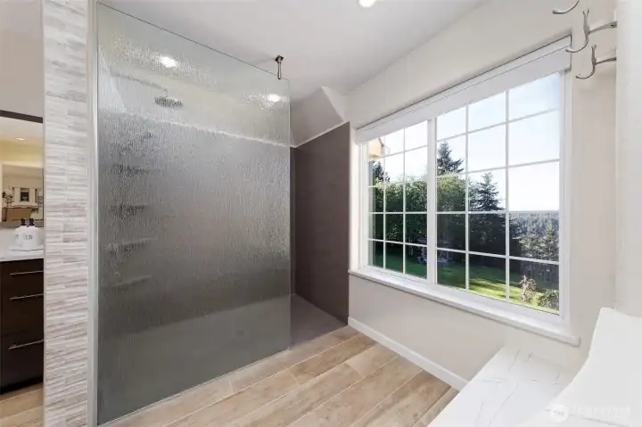 Lovely large walk-in shower with Corian walls and a high-tech shower that you can control with voice commands to use preset preferences. Compatable with Google or Alexa.