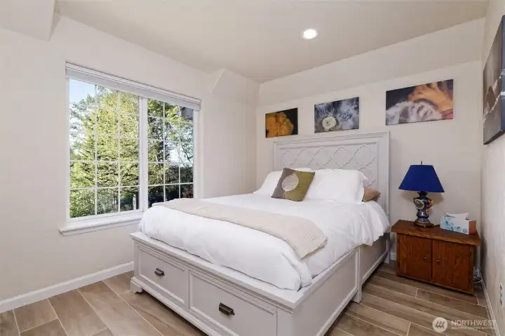 Guest bedroom with a view of Puget Sound and the Olympic mountains, Italian porcelain floors.