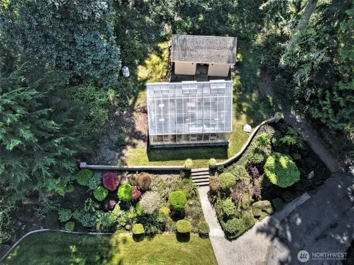 Aerial of the greenhouse and garden shed. Notice all the lovely well-established landscaping plants!