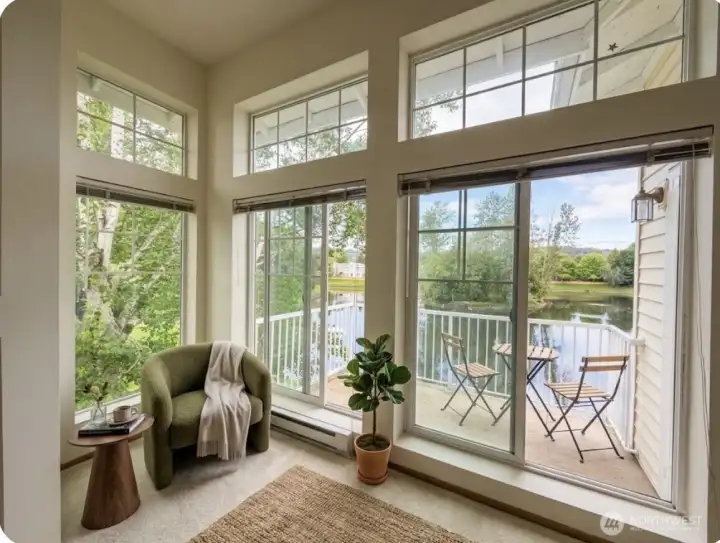 View of lake from the virtually staged living room and balcony.