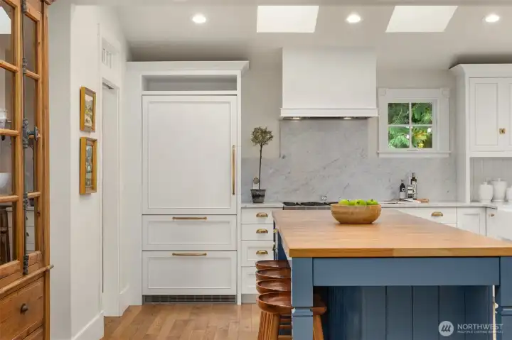High-end appliances include 36” 6-burner range.