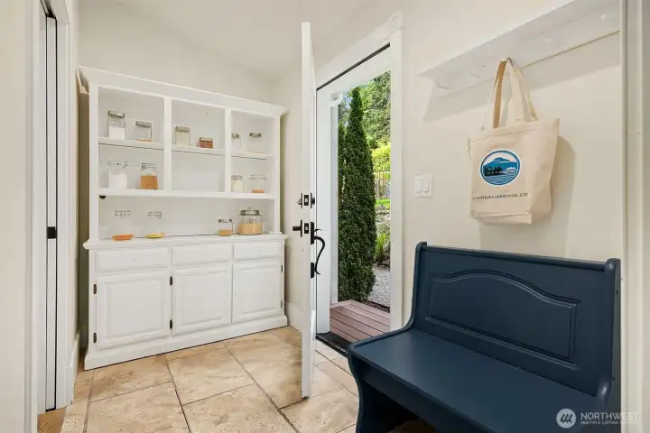 Fantastic mudroom/pantry space with tumbled travertine oversized tiles floors has separate entry. This room adjoins the laundry room, a perfect space to enter from the garden, take off your boots, and wash your hands in the laundry room sink.