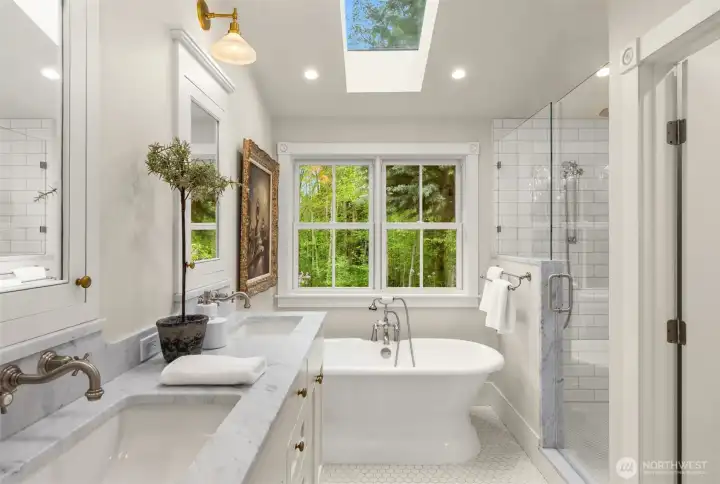 Sumptuous bathroom with skylight, soaking tub, marble, heated floors, large shower and separate water closet.