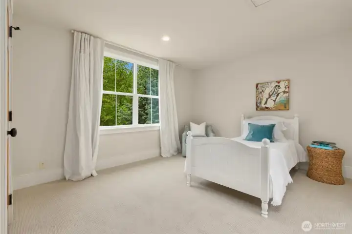 Second bedroom on upper floor with walk-in closet (not shown).