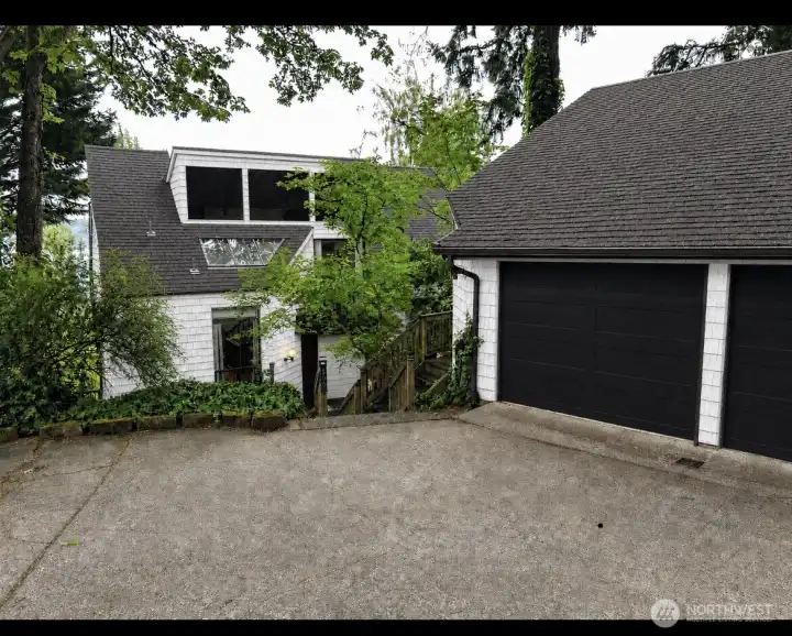 Al generated to visualize exterior painting (cedar siding white and garage door black). Al generated to visualize exterior painting (cedar siding white and garage door black).