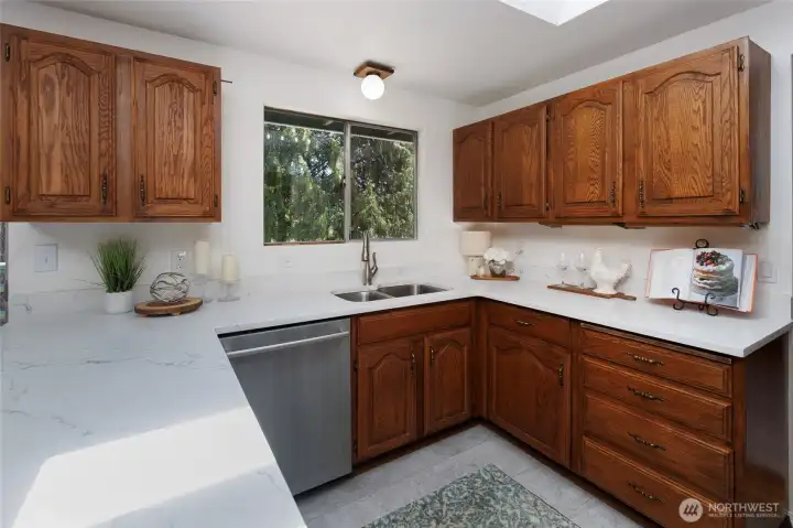 Newer quartz countertops and stainless steel appliances.