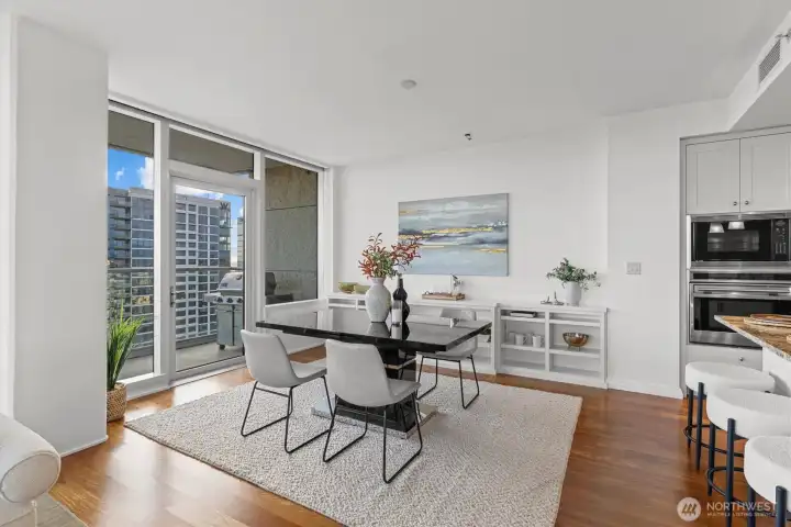 Dining area with built-in storage opens to the balcony. Dining area with built-in storage opens to the balcony.
