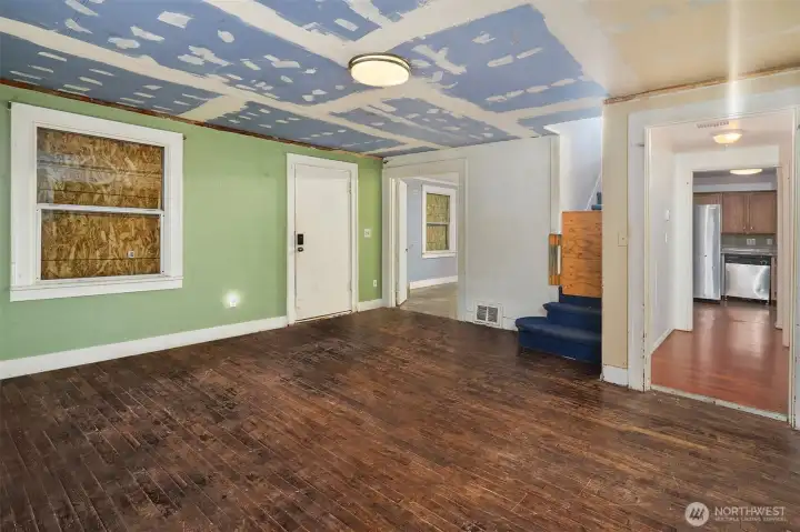 View of front entry door, stairs to second story and hallway to bathroom and kitchen. View of front entry door, stairs to second story and hallway to bathroom and kitchen.