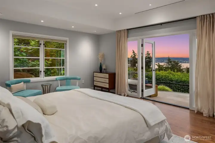 Primary bedroom with French doors opening to private patio. Primary bedroom with French doors opening to private patio.