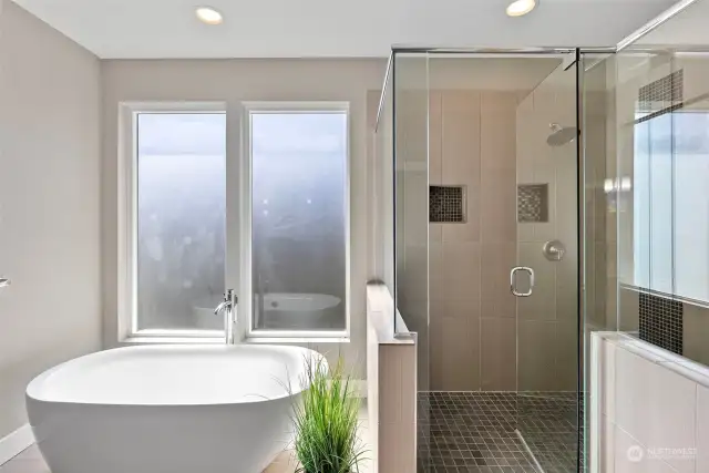 Free-standing soaking tub in primary bath.